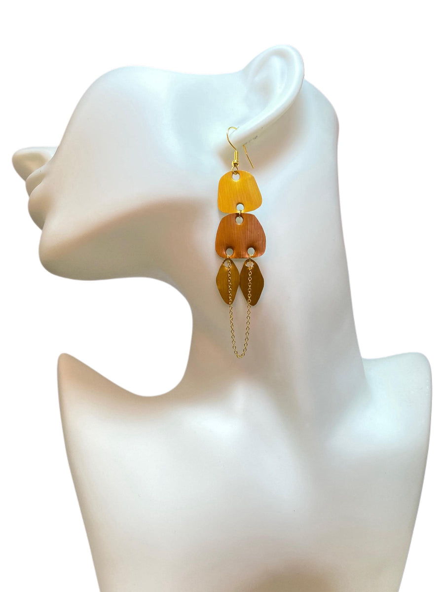 gold, copper, bronze upcycled nespresso capsules earrings on a white mannequin and white background