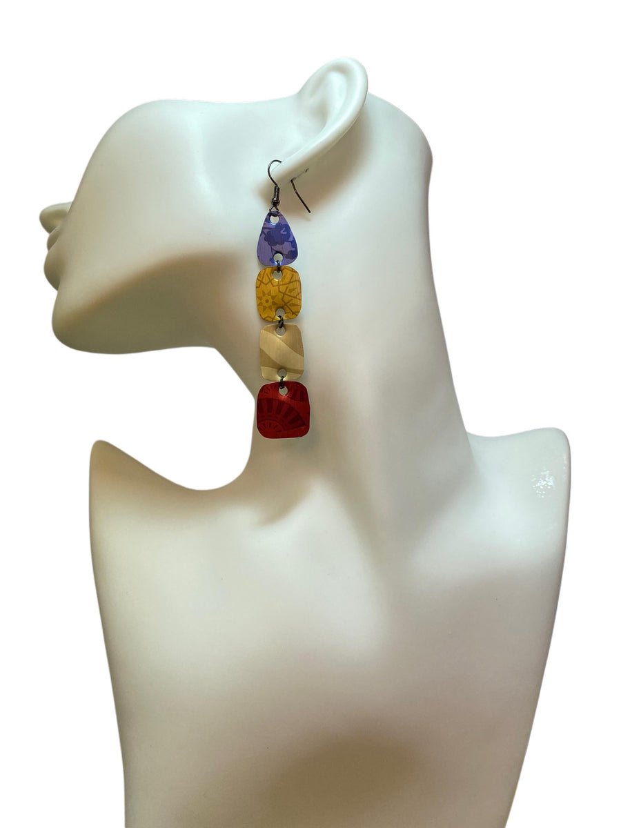 blue, brown, red, colourful earrings made from upcycled nespresso pods on awhite mannequin and background