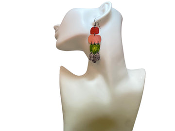 colourful oriental design earrings in red, peach, green and grey colour made from upcycled nespresso capsules on a white mannequin and white background