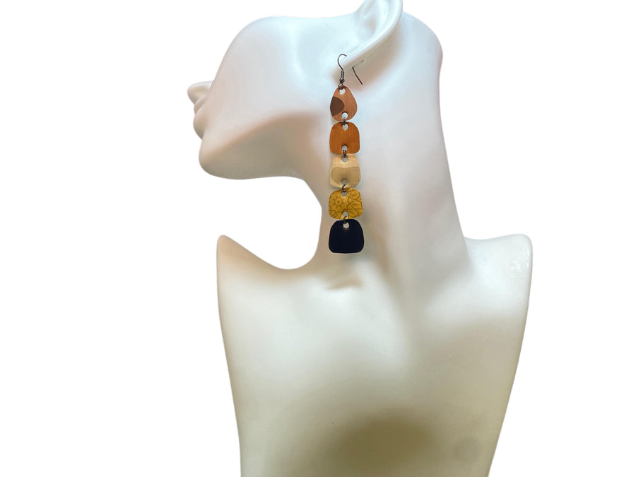 earthy coloured, brown black gold long earrings made from upcycled nespresso capsules on white mannequin and white background