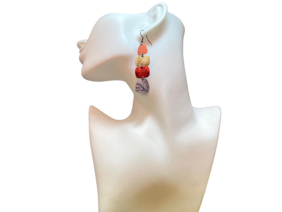 peach, sand, red, silver earrings made from upcycled nespresso capsules on a white mannequin and white background