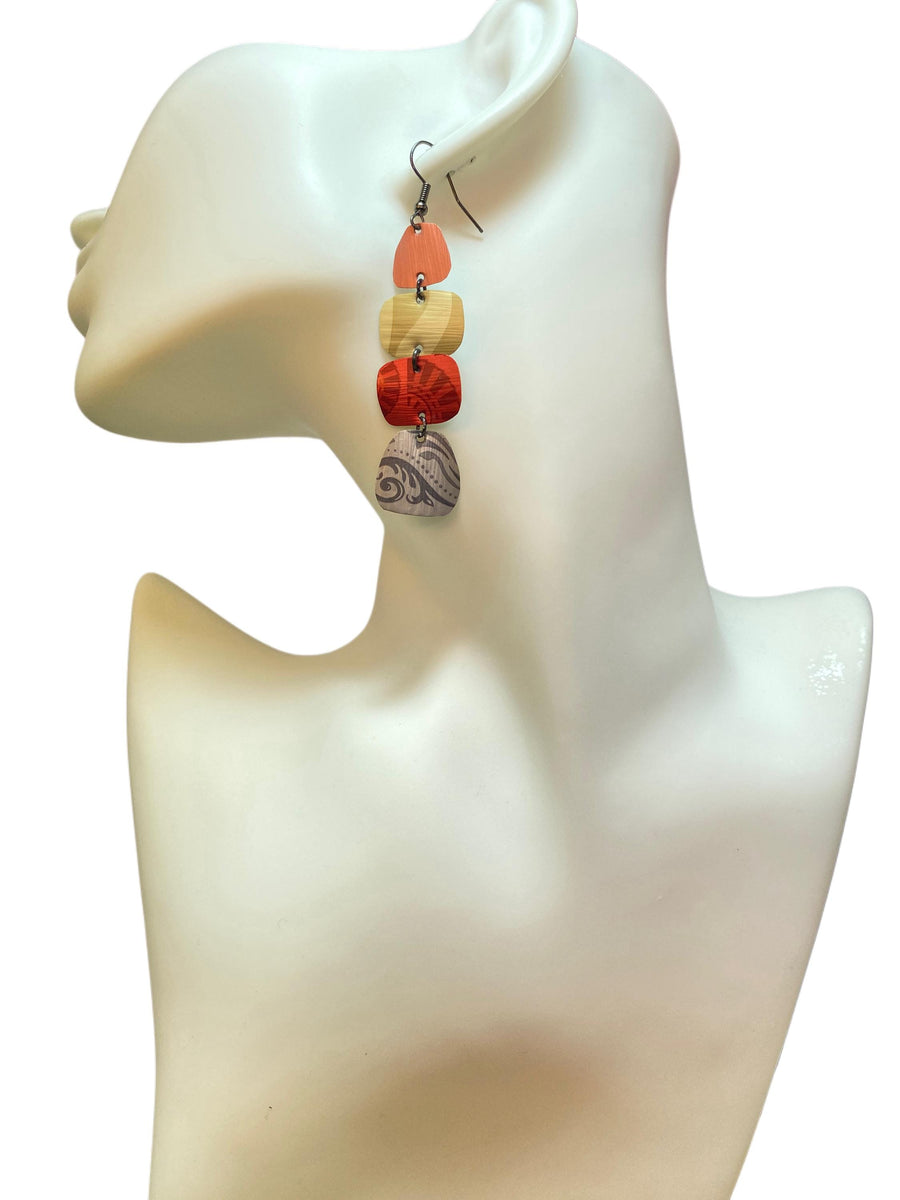 peach, sand, red, silver earrings made from upcycled nespresso capsules on a white mannequin and white background