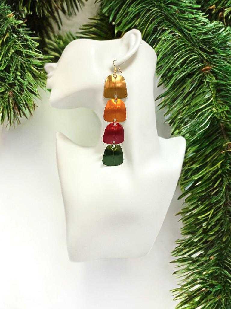 gold orange red green statement earrings made from Upcycled nespresso capsules on a white mannequin and xmas themed  background