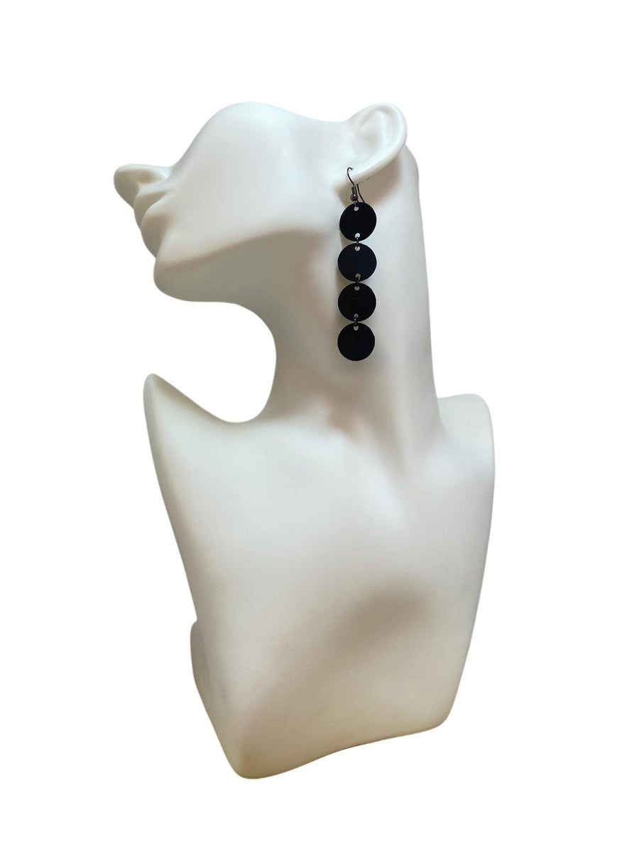 black circle design earrings made from upcycled bicycle inner tube on a white mannequin