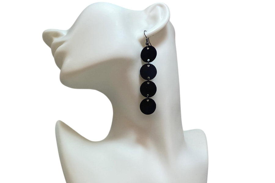 black circle design earrings made from upcycled bicycle inner tube on a white mannequin