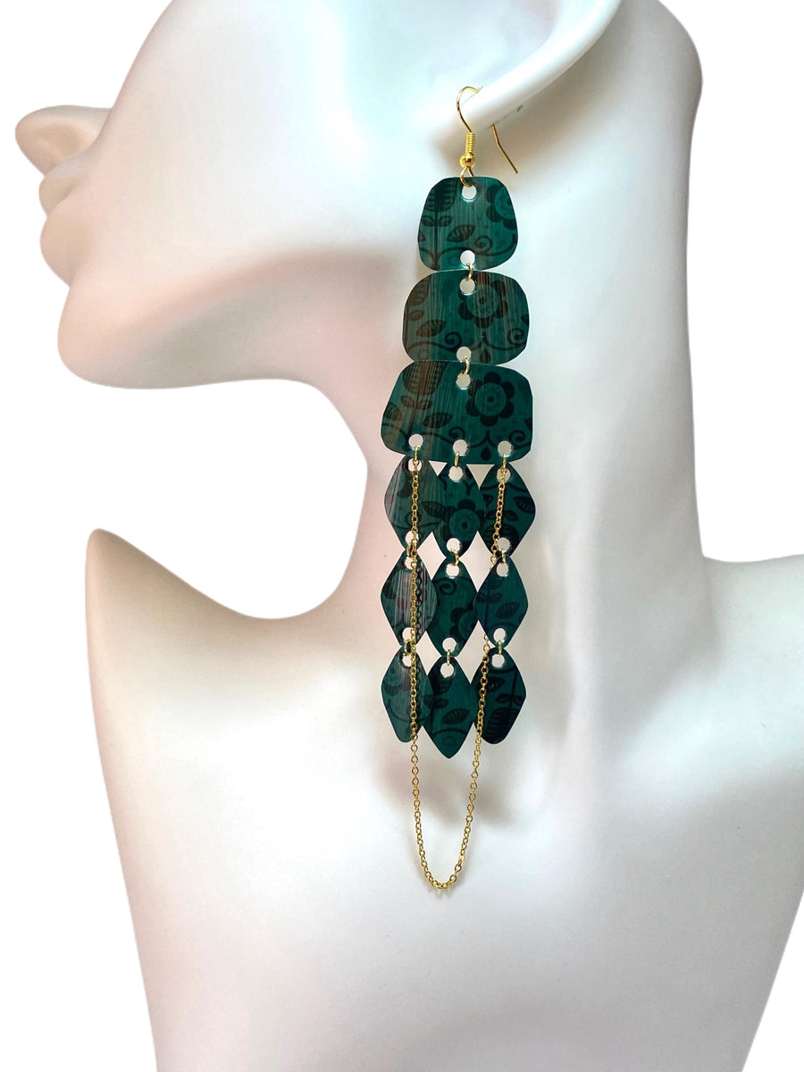 dark green long chandelier earrings made from upcycled nespresso capsules on a white mannequin and background