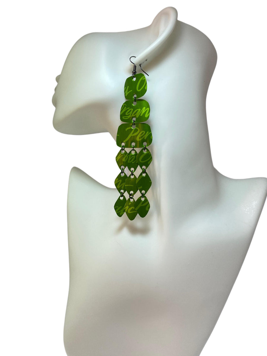 large, bold, bright green coloured chandelier earrings made from nespresso capsules on a white mannequin and background