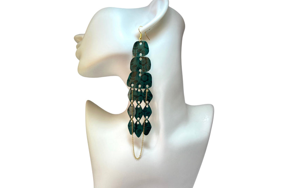 dark green long chandelier earrings made from upcycled nespresso capsules on a white mannequin and background