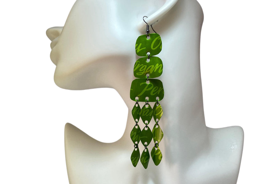 large, bold, bright green coloured chandelier earrings made from nespresso capsules on a white mannequin and background