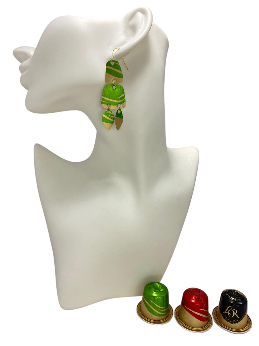 Upcycled, lime green-golden Nespresso capsules earrings on a white mannequin display and 3 nespresso pods