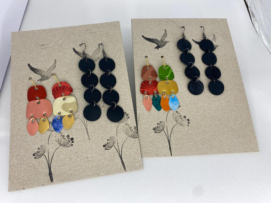 2 pairs of earrings, colourful,upcycled Nespresso capsule and bicycleinner tube earrings on a carton