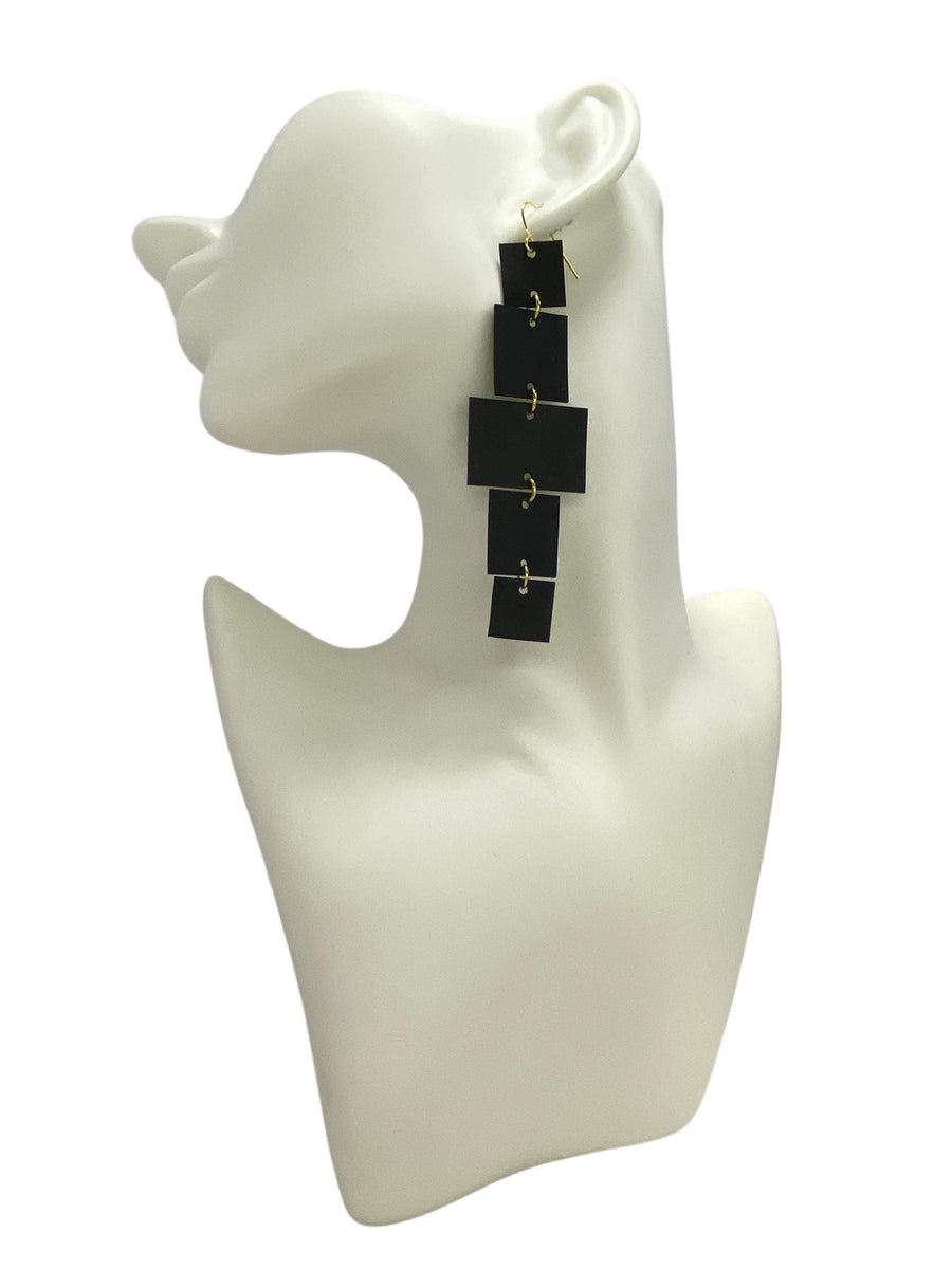 black golden upcycled bicycle inner tube, geometric earrings on a on a white head mannequin