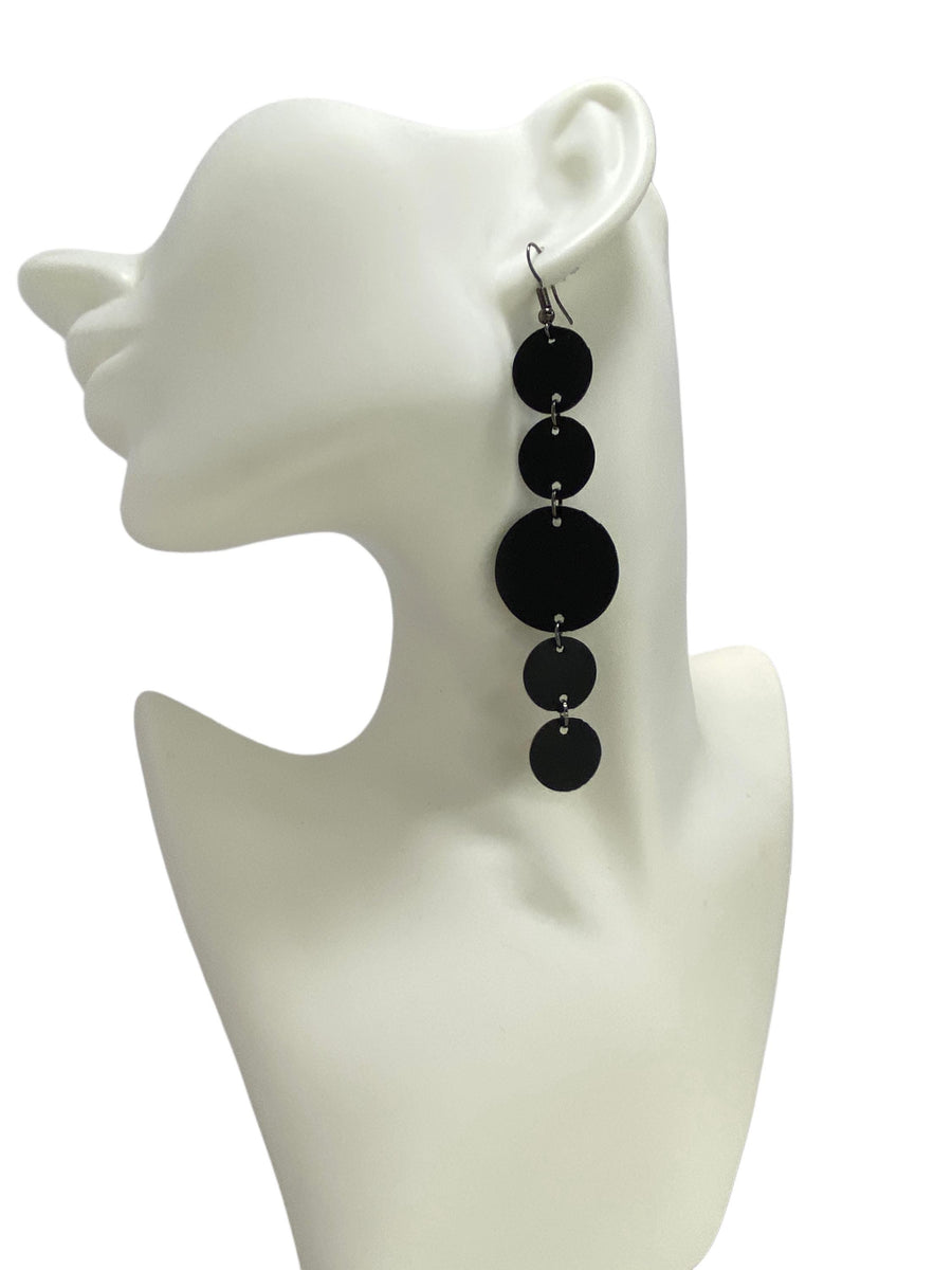 Black, long earring features  rubber discs connected with jumprings made from upcycled bicycle inner tubes, on a white head mannequin