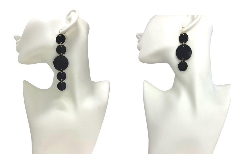 2 pairs of bicycle inner tube, black-golden, geometric, disc earrings on two white mannequins