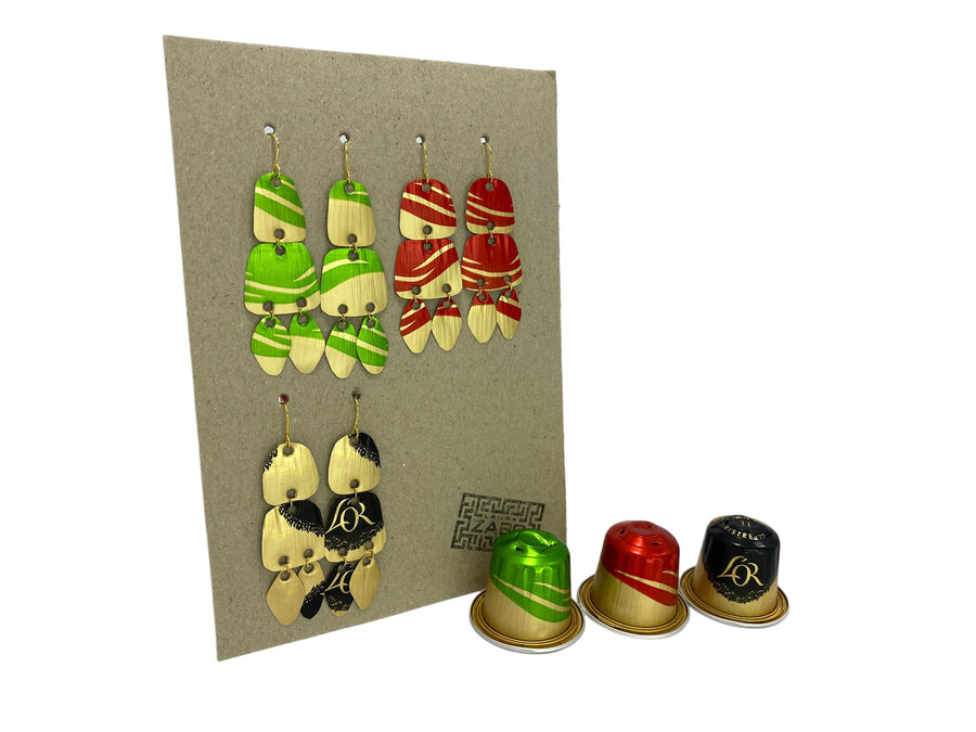 Upcycled Nespresso capsules earrings set on carton paper display with three nespresso pods on a white background