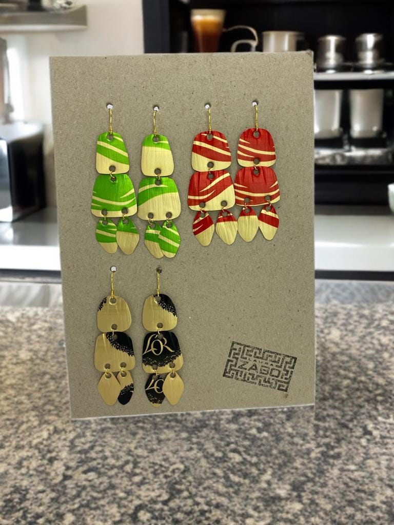 Upcycled Nespresso capsules earrings set on carton  paper display on kitchen desk