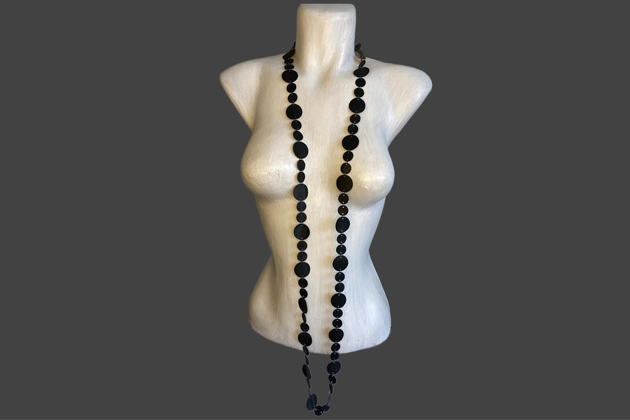 upcycled bicycle inner tube, disc shaped black  necklace displayed on a mannequin