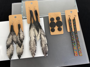 4 pairs of black silver upcycled bicycle inner tube earrings in different lengths and shapes, laura Zabo statement jewelry