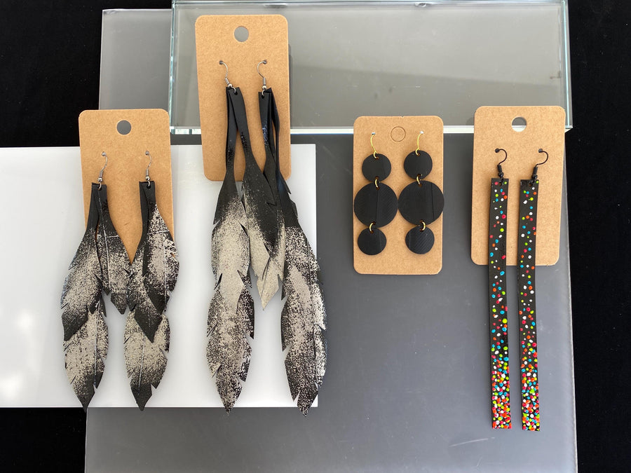 4 pairs of black silver upcycled bicycle inner tube earrings in different lengths and shapes, laura Zabo statement jewelry