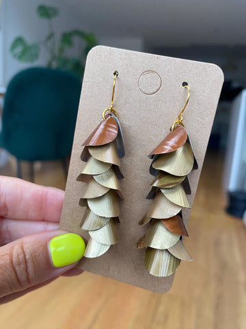 gold bronze cascading earrings made from upcycled nespresso pods, capsules on a paper display