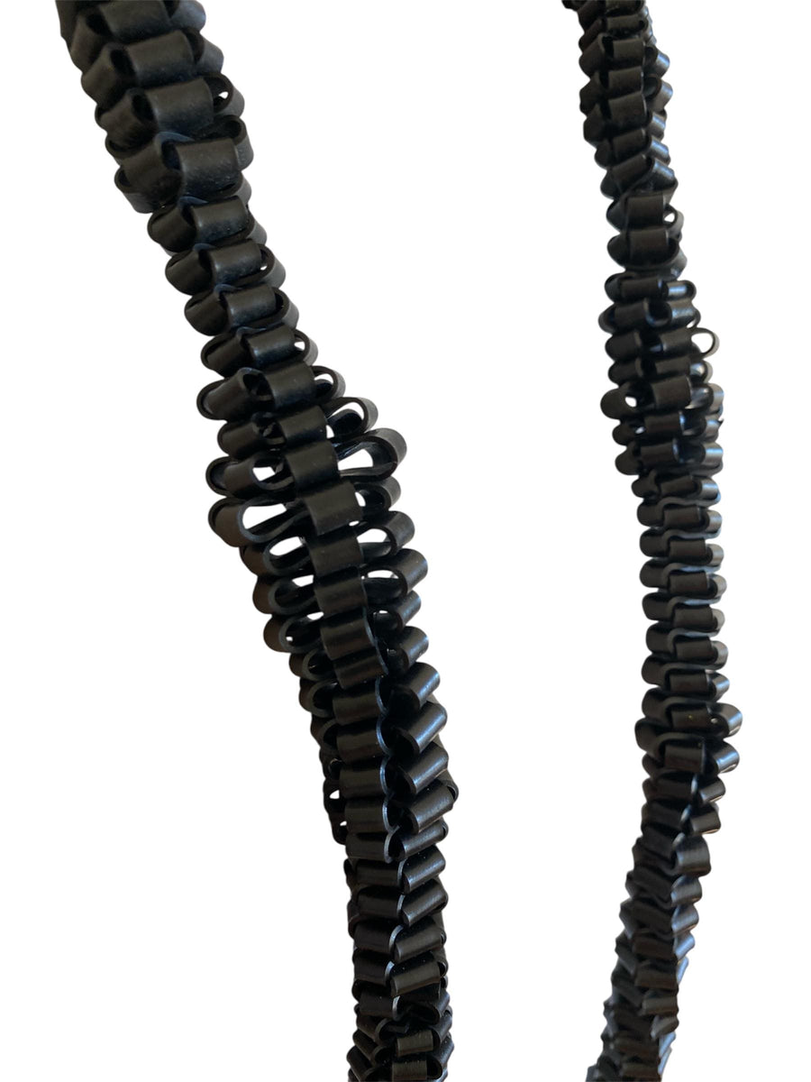 very bold, black scultural necklace made from upcycled bicycle inner tube strips on a mannequin