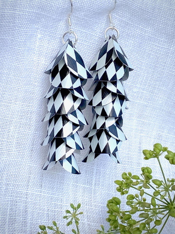 black white cascade earrings made from upcycled nespresso capsule aluminium on a white linen background and green plant