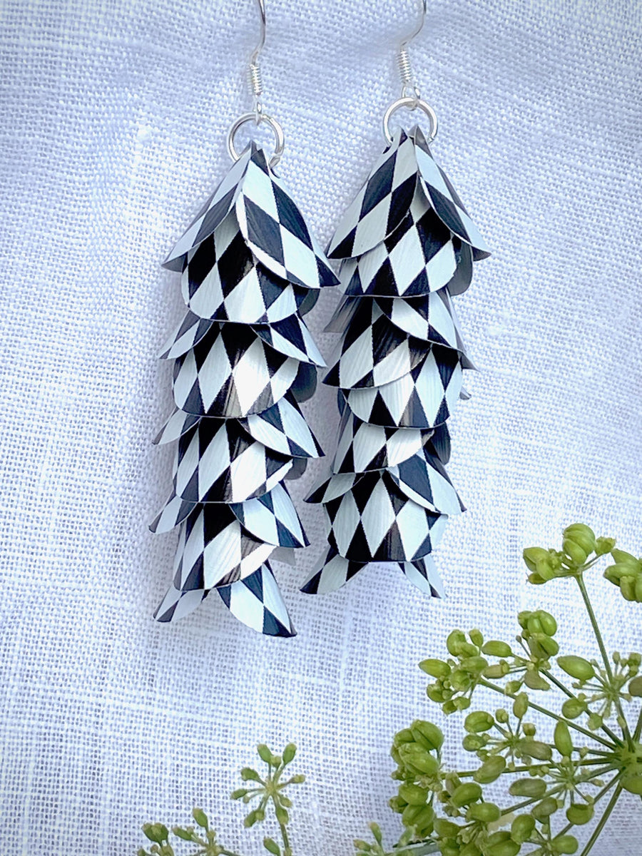 black white cascade earrings made from upcycled nespresso capsule aluminium on a white linen background and green plant