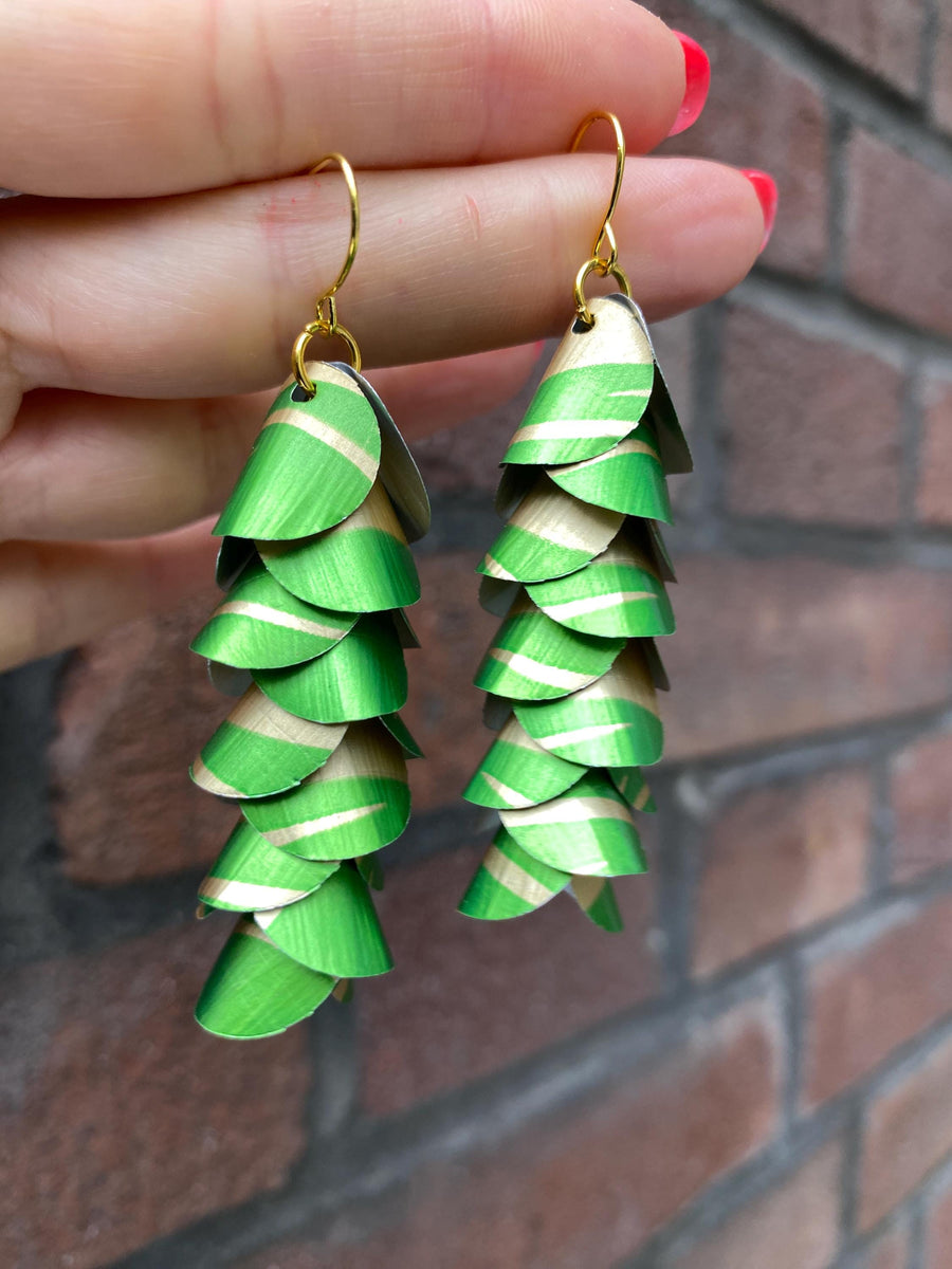 lime green gold coloured cascading earrings made from upcycled nespresso pods on a brick wall background