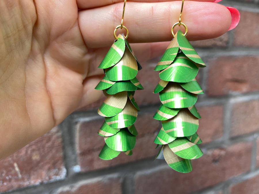 lime green gold coloured cascading earrings made from upcycled nespresso pods on a brick wall background