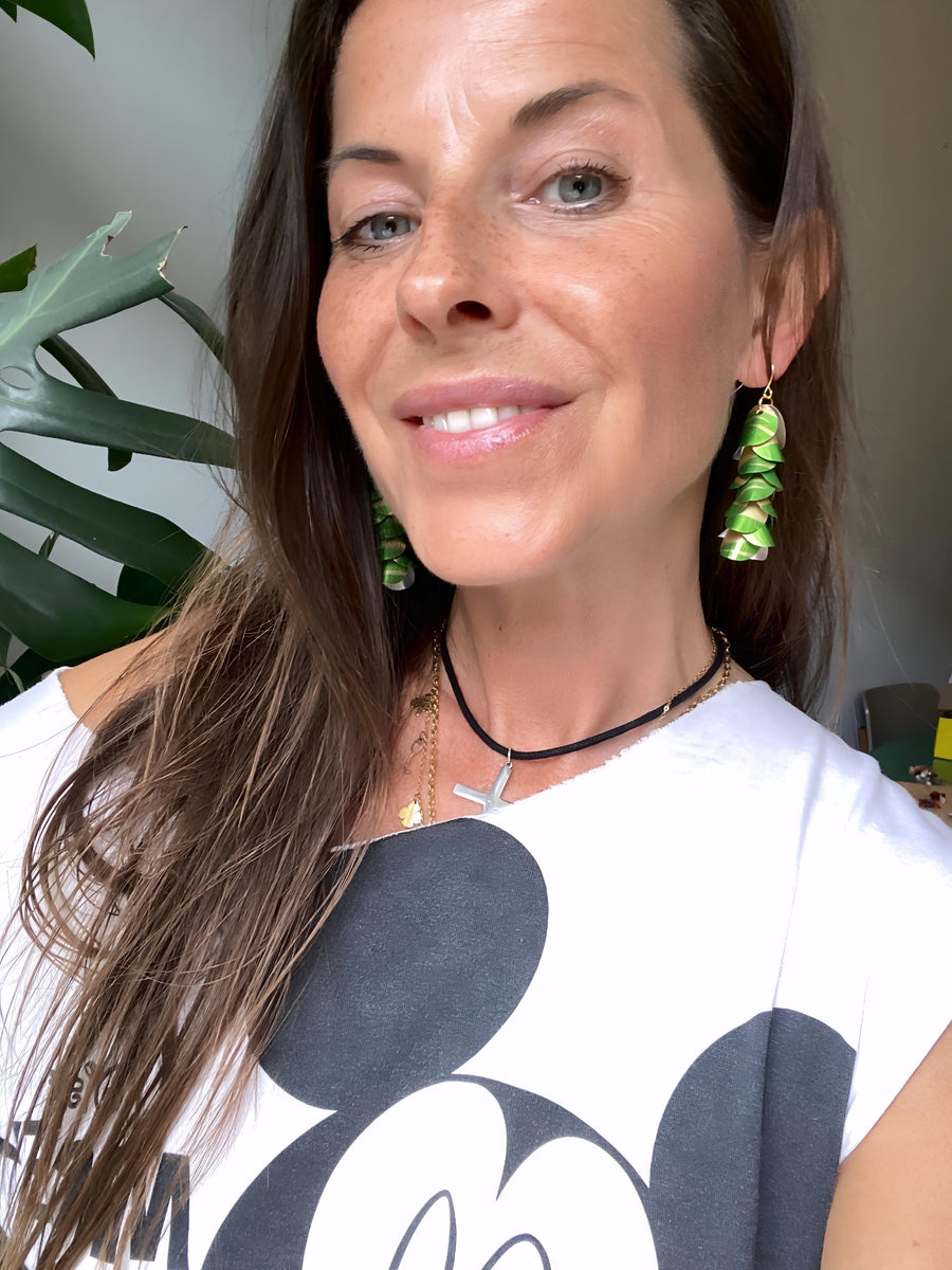 model wears lime green gold cascade earrings made from upcycled nespresso pod aluminium