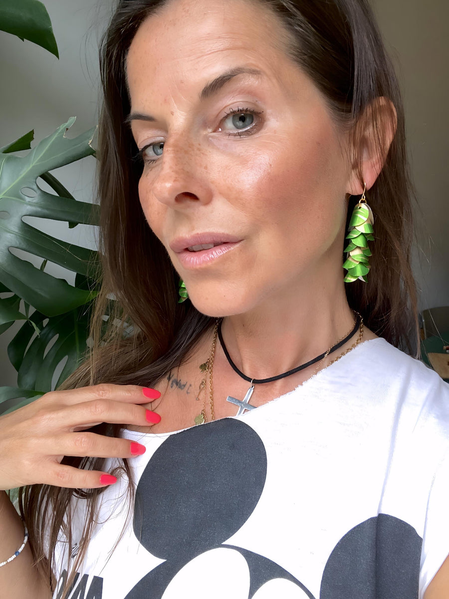 model wears lime green gold cascade earrings made from upcycled nespresso pod aluminium