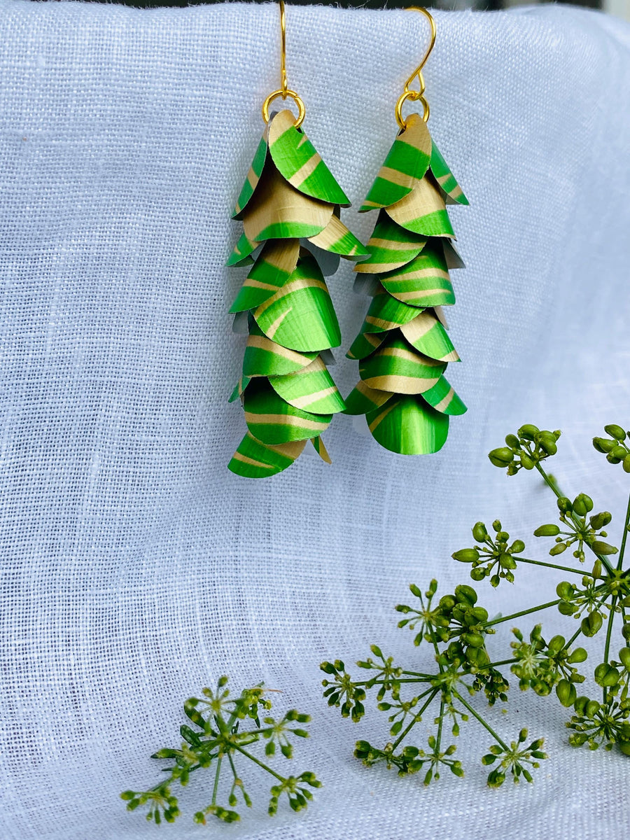 lime green gold coloured cascading earrings made from upcycled nespresso pods on a linen background and green flower