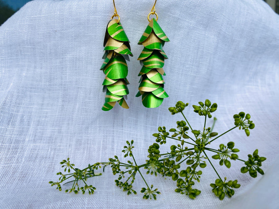 lime green gold coloured cascading earrings made from upcycled nespresso pods on a linen background and green flower