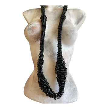 very bold, black scultural necklace made from upcycled bicycle inner tube strips on a mannequin