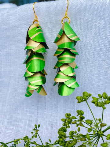 lime green gold coloured cascading earrings made from upcycled nespresso pods on a linen background and green flower