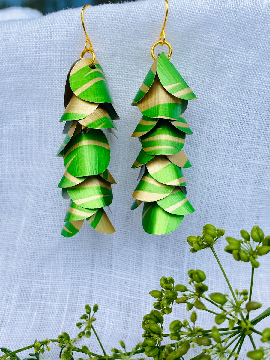 lime green gold coloured cascading earrings made from upcycled nespresso pods on a linen background and green flower