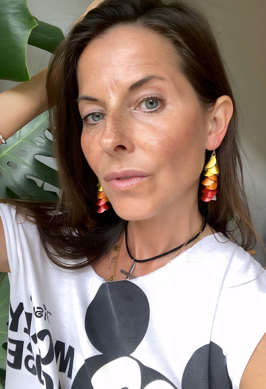 model wears sunset, sunrise themed gold-orange-red earrings made from upcycled nespresso pod aluminium
