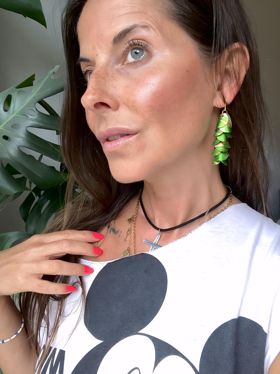 model wears lime green gold cascade earrings made from upcycled nespresso pod aluminium