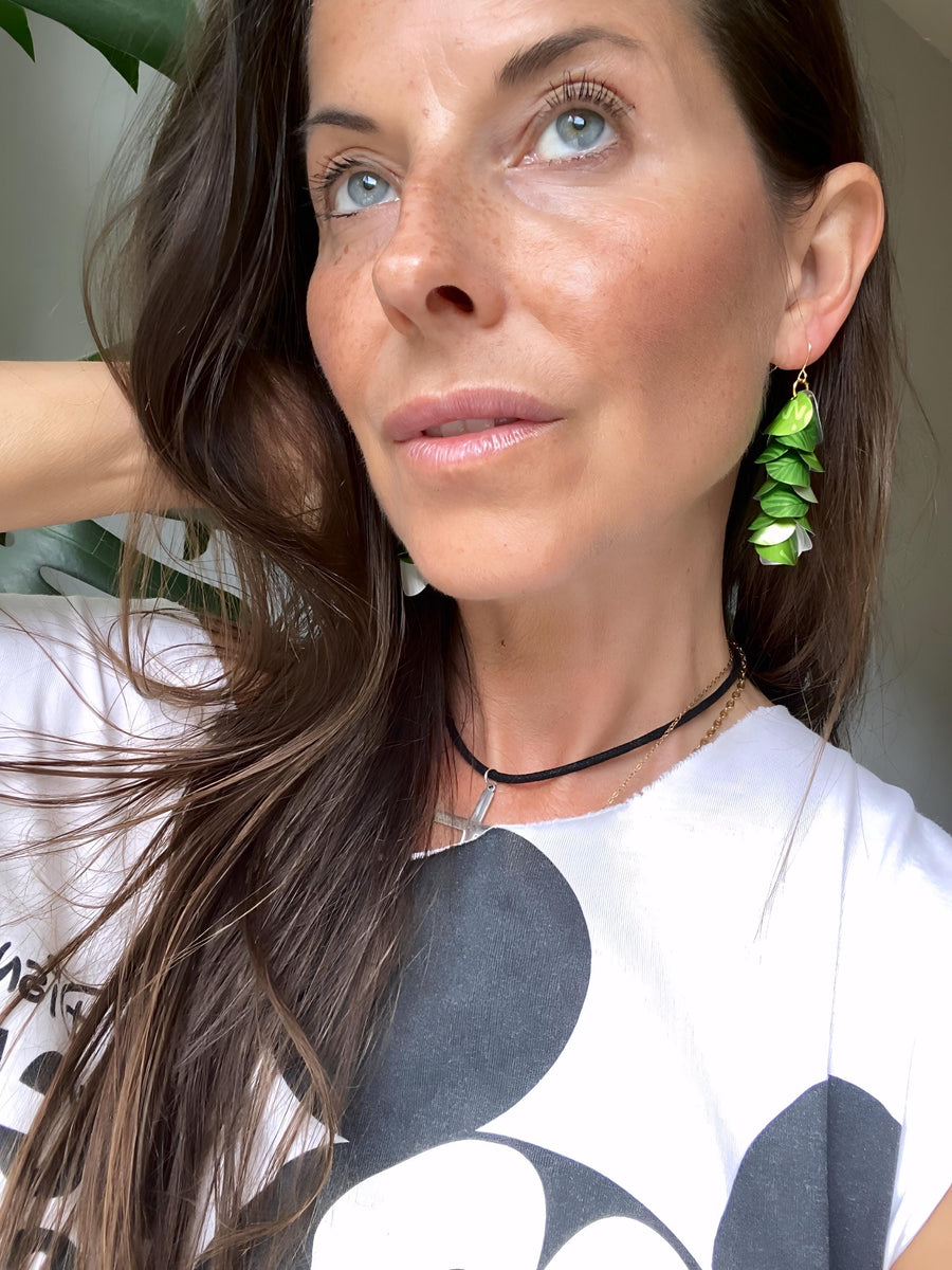 model wears bright lime green cascade earrings made from upcycled nespresso pod aluminium