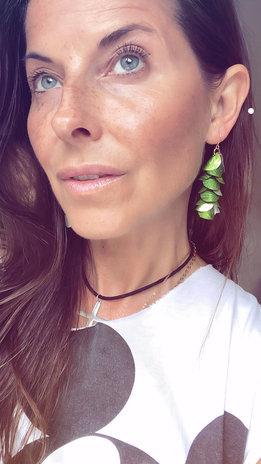 model wears bright lime green cascade earrings made from upcycled nespresso pod aluminium