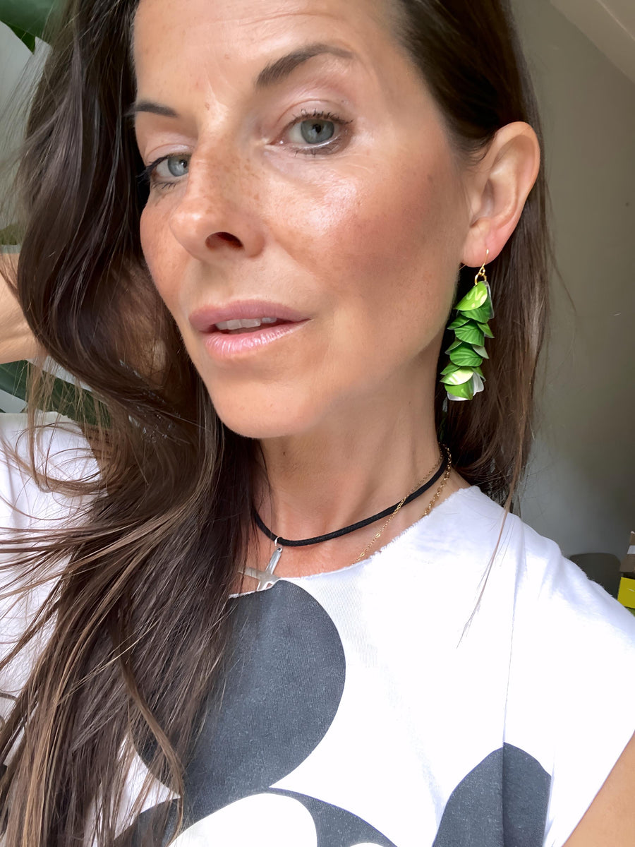 model wears bright lime green cascade earrings made from upcycled nespresso pod aluminium