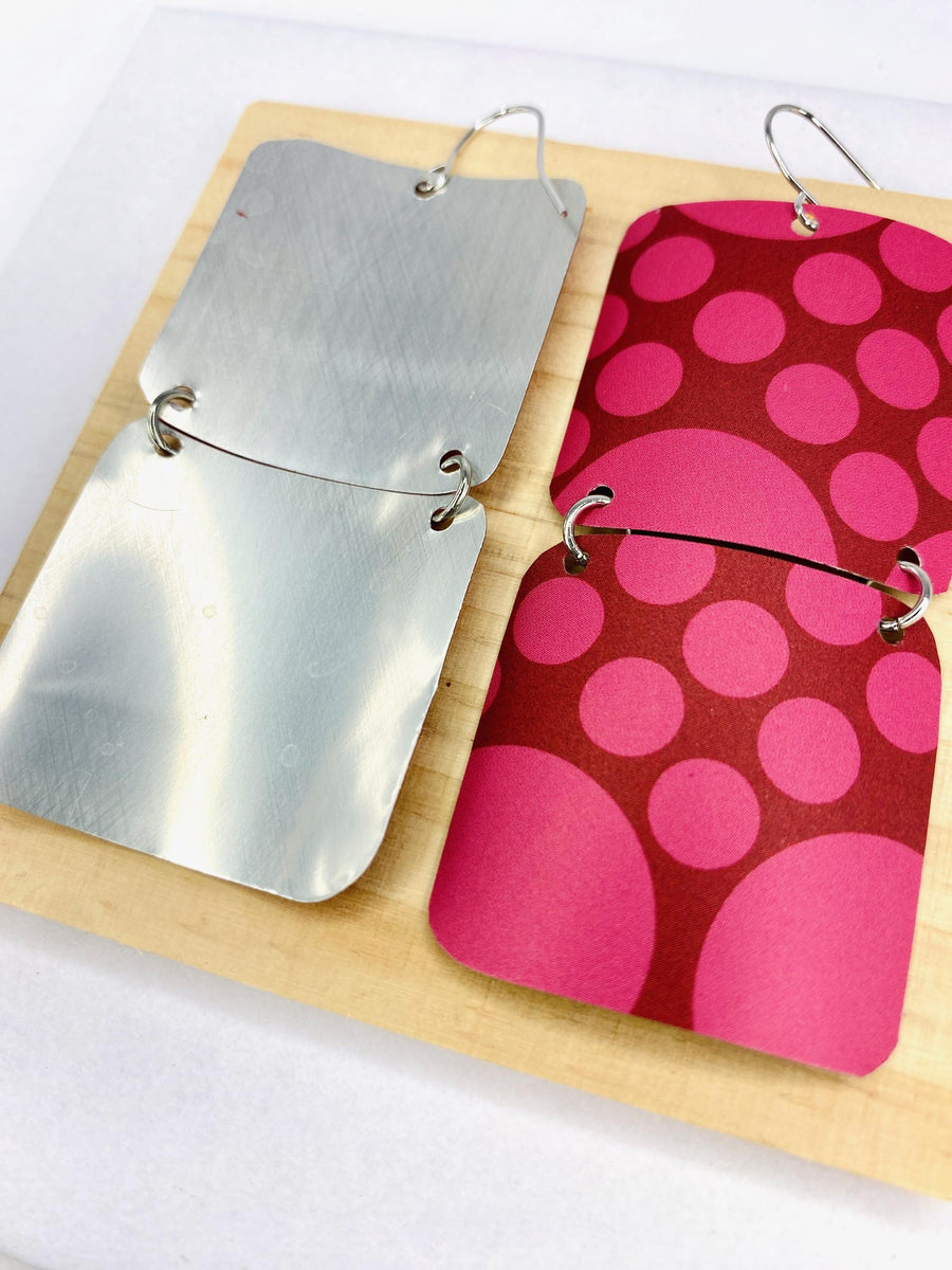 squared cherry coloured, polka dot earrings made from a craft beer can on white background