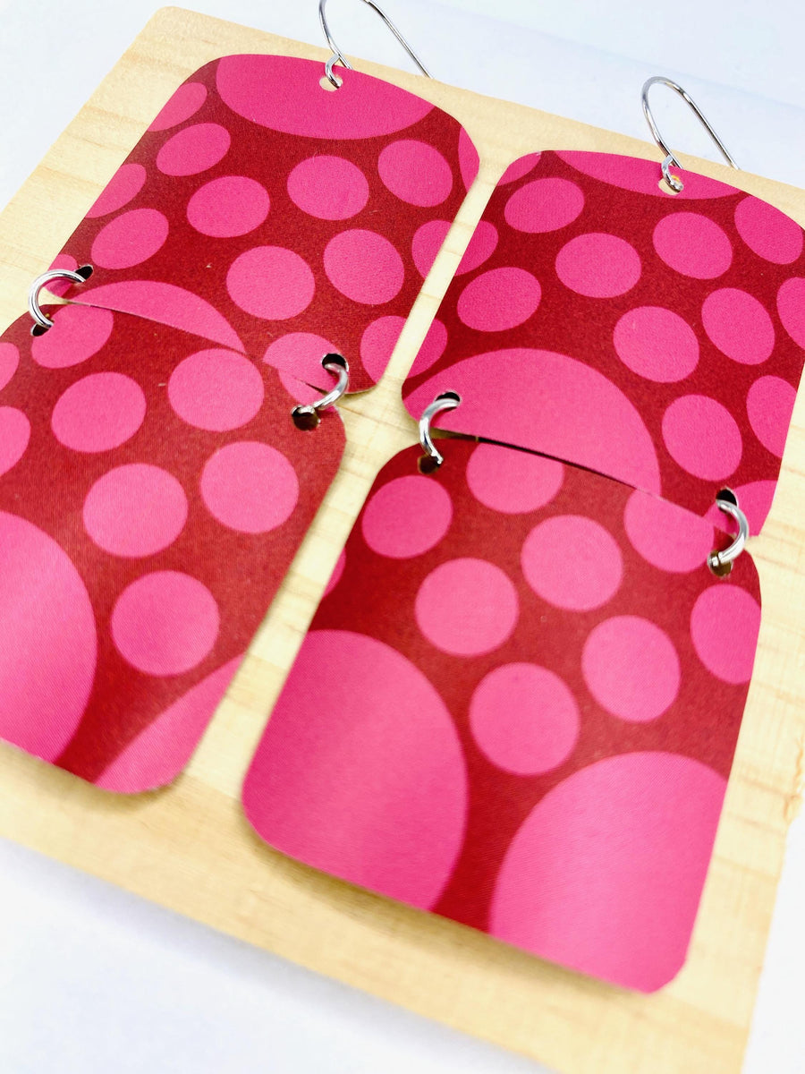 squared cherry coloured, polka dot earrings made from a craft beer can on white background