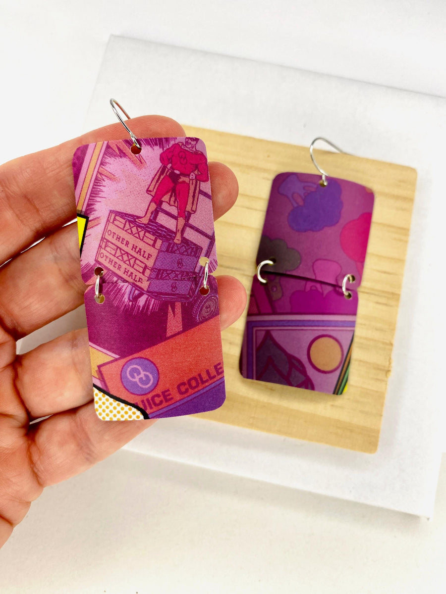 purple earrings made from upcycled craft beer can on a wooden and white background