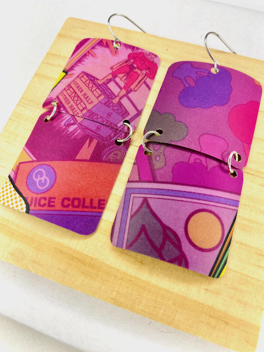 purple earrings made from upcycled craft beer can on a wooden and white background