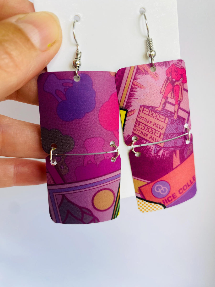 purple earrings made from upcycled craft beer can on a wooden and white background
