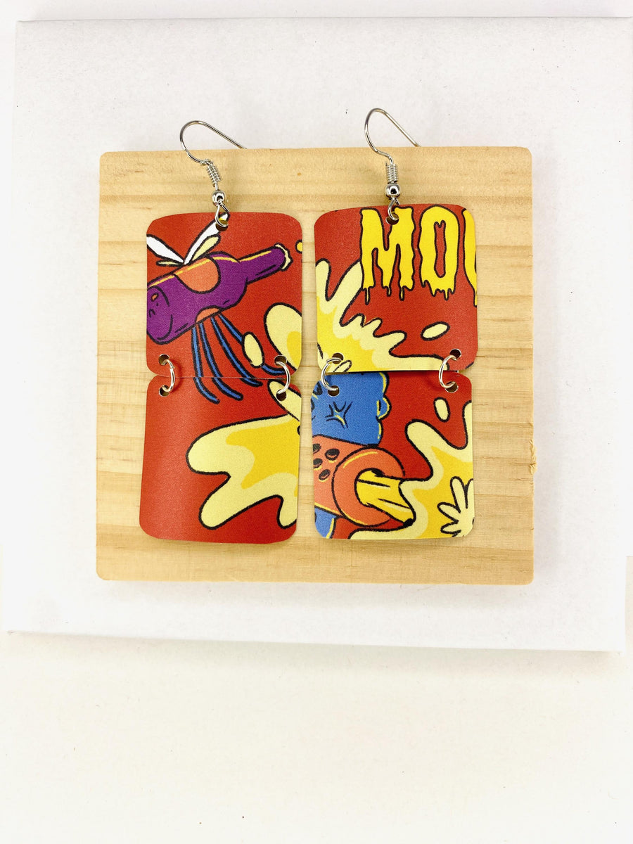 comic, graffiti style earrings made from an upcycled craft beer can in orange, yellow colours, on a wooden and white background
