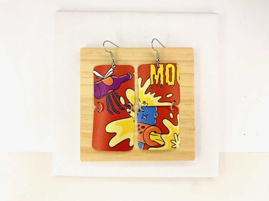 comic, graffiti style earrings made from an upcycled craft beer can in orange, yellow colours, on a wooden and white background
