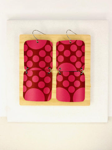 squared cherry coloured, polka dot earrings made from a craft beer can on white background