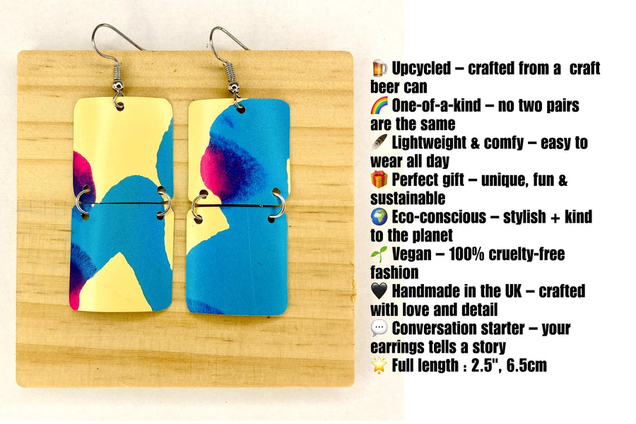squared shape, abstract, upcycled earrings in blue, yellow, magenta colours made from a craft beer can,  on a wooden background with description